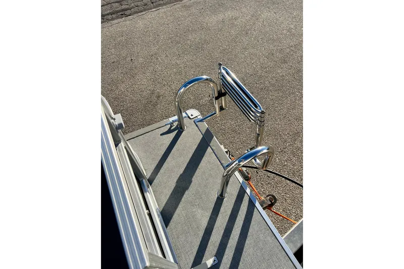 Slide: The Image of Starcraft EX 20 C 2021 boat ladder on deck, featuring stainless steel rails. - 73