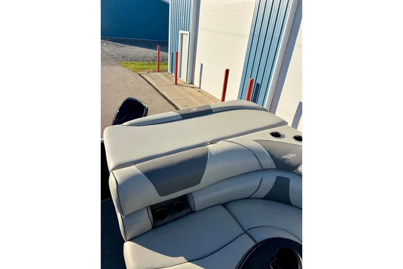 Slide: The Image of 2021 Starcraft EX 20 C boat interior with gray seating and cup holders. - 68