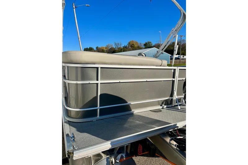 Slide: The Image of 2021 Starcraft EX 20 C pontoon boat with beige seating and metal railing. - 32