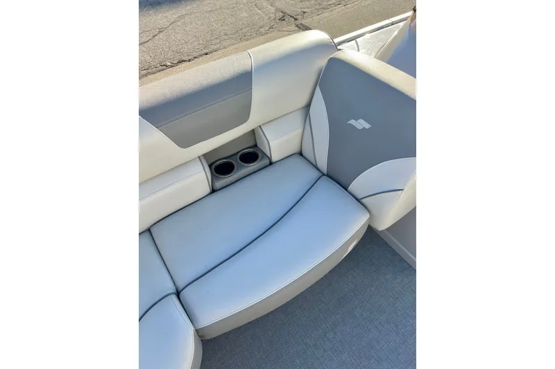 Slide: The Image of 2021 Starcraft EX 20 C boat seat with cup holders, featuring gray and white upholstery. - 41