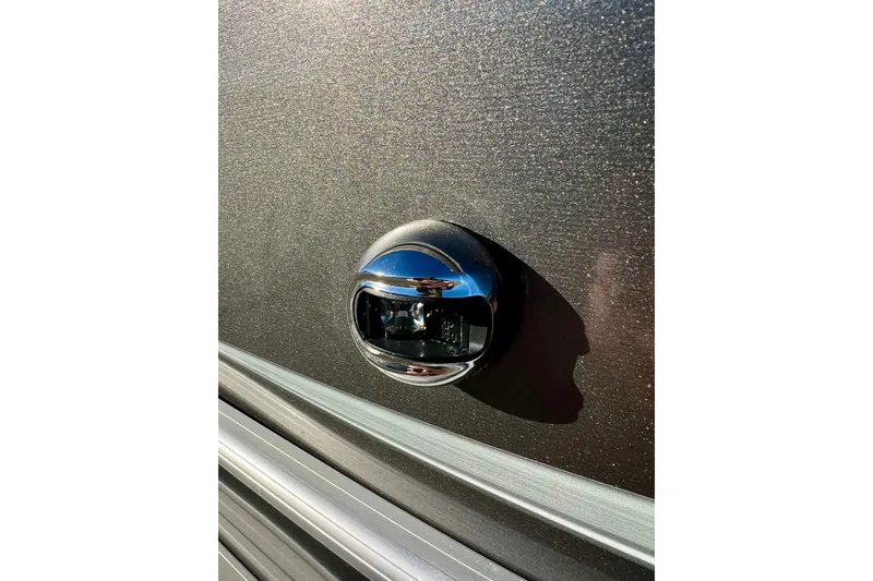 Slide: The Image of Close-up of a 2021 Starcraft EX 20 C boat's chrome detail on a textured surface. - 33