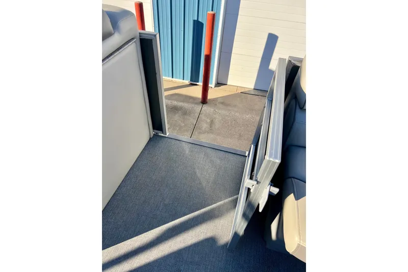 Slide: The Image of Open side gate of 2021 Starcraft EX 20 C boat, showing interior and dock. - 75