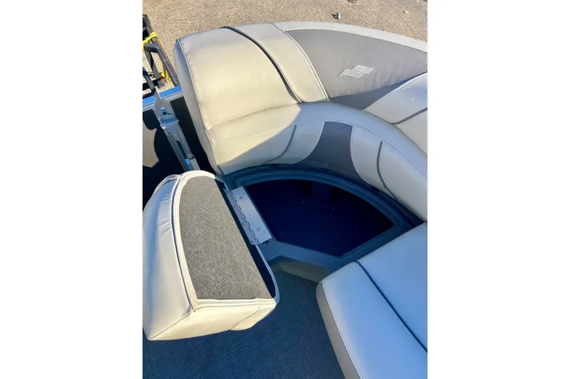 Slide: The Image of 2021 Starcraft EX 20 C boat interior with open storage compartment. - 43