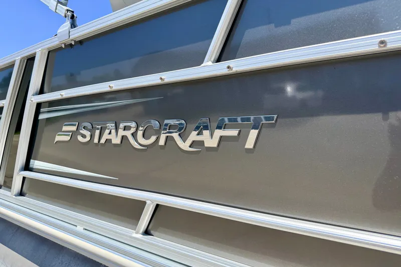 Slide: The Image of 2021 Starcraft EX 20 C boat logo on metallic surface. - 7