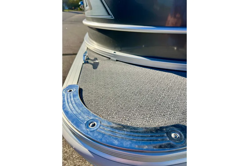 Slide: The Image of 2021 Starcraft EX 20 C boat deck detail with textured surface and metal trim. - 26