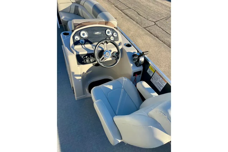 Slide: The Image of 2021 Starcraft EX 20 C boat interior with steering console and seating. - 52
