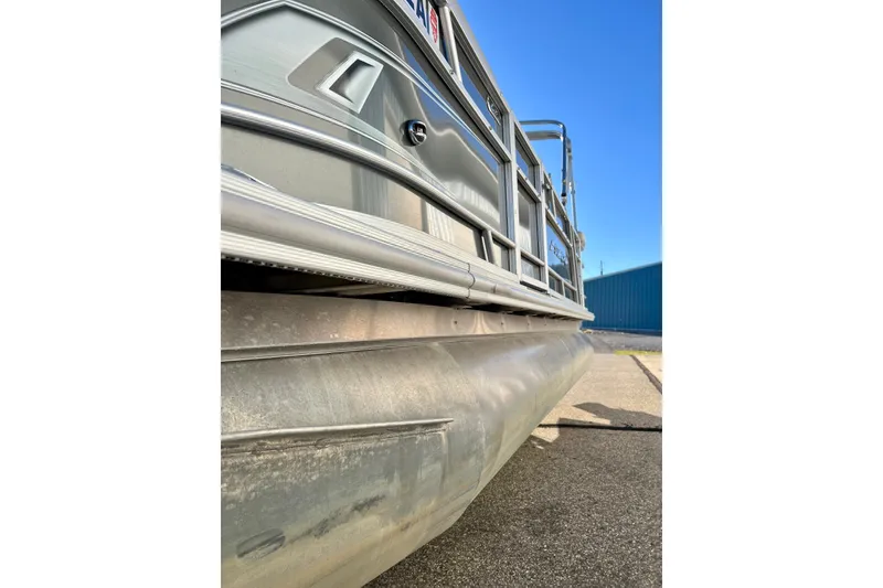 Slide: The Image of 2021 Starcraft EX 20 C pontoon boat, side view, showcasing aluminum structure and sleek design. - 82