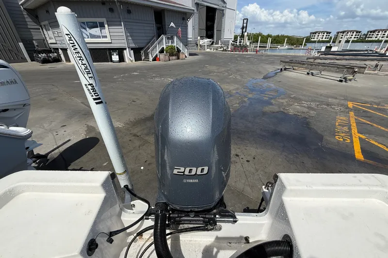 Slide: The Image of 2013 Sportsman Masters 227 Bay Boat with Yamaha 200 engine at a marina dock. - 24