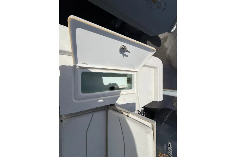 Slide: The Image of Open storage compartment on a 2013 Sportsman Masters 227 Bay Boat. - 22