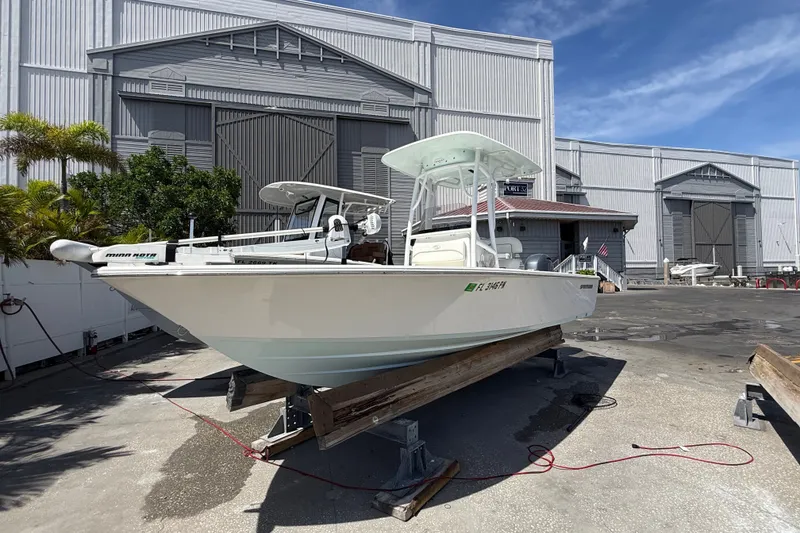 Slide: The Image of 2013 Sportsman Masters 227 Bay Boat on display outside a large warehouse. - 2