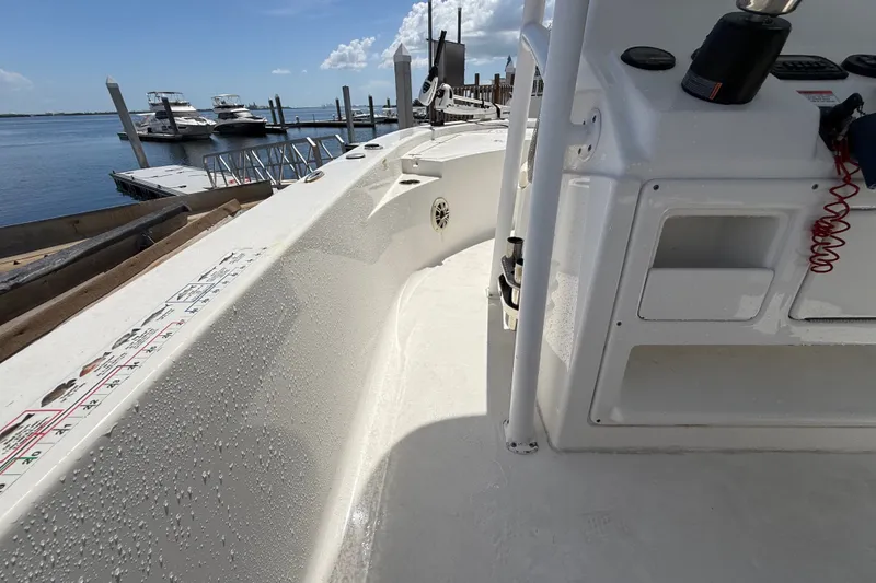 Slide: The Image of 2013 Sportsman Masters 227 Bay Boat interior with water droplets, docked by the marina. - 14