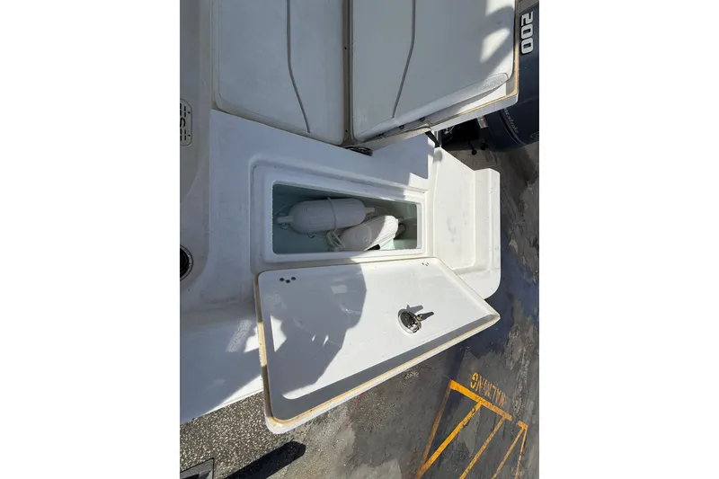 Slide: The Image of Open storage compartment on 2013 Sportsman Masters 227 Bay Boat, showing interior space. - 23