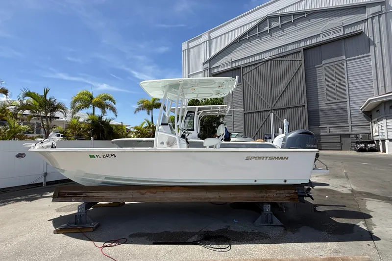 The Image of 2013 Sportsman Masters 227 Bay Boat on display outside a large warehouse. - 1