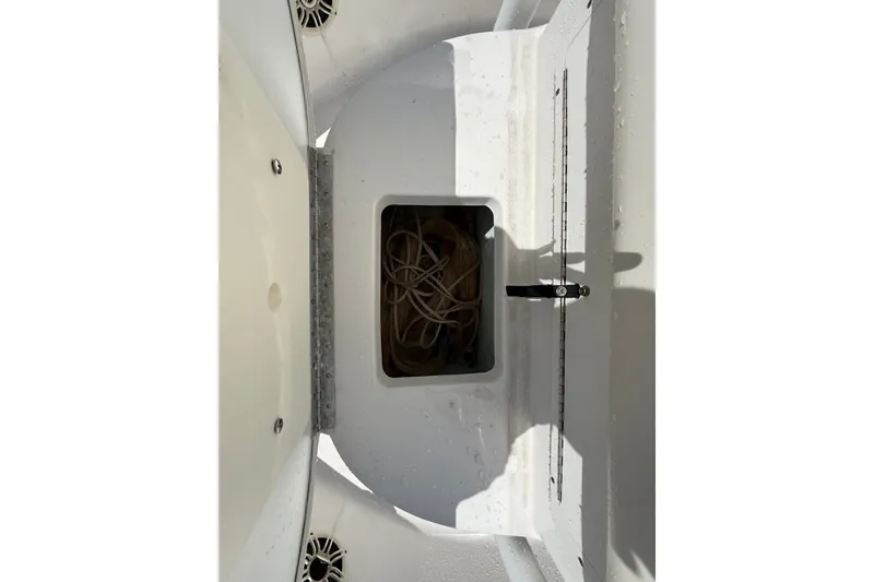 Slide: The Image of 2013 Sportsman Masters 227 Bay Boat storage compartment with rope inside. - 31