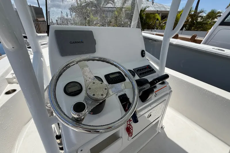 Slide: The Image of Steering console of 2013 Sportsman Masters 227 Bay Boat with Garmin navigation system. - 27