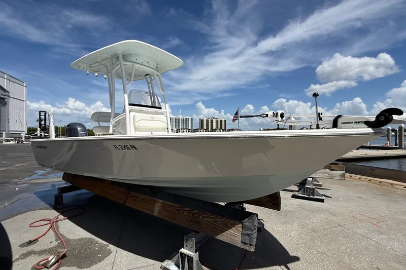 Slide: The Image of 2013 Sportsman Masters 227 Bay Boat on dock, clear sky background. - 3