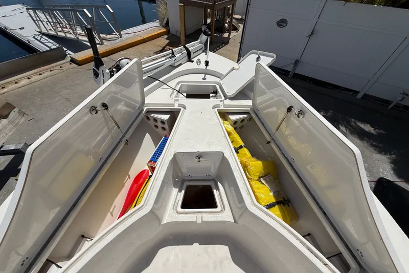 Slide: The Image of 2013 Sportsman Masters 227 Bay Boat storage compartments open at dockside. - 11