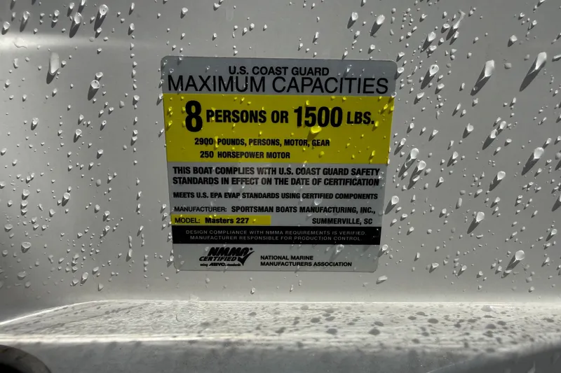 Slide: The Image of 2013 Sportsman Masters 227 Bay Boat capacity label, 8 persons or 1500 lbs, U.S. Coast Guard compliant. - 15