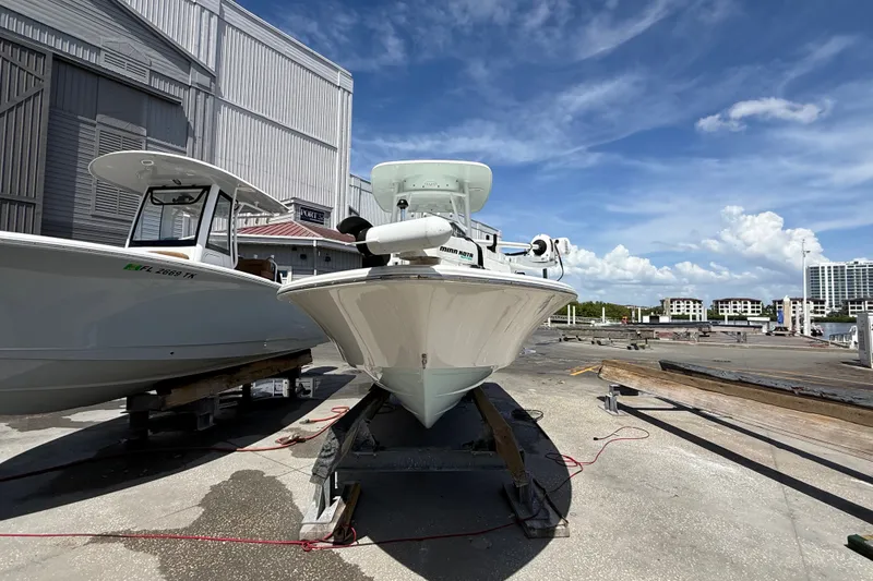 Slide: The Image of 2013 Sportsman Masters 227 Bay Boat on dock under clear blue sky. - 6