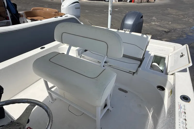 Slide: The Image of 2013 Sportsman Masters 227 Bay Boat interior with seating and Yamaha engine. - 21