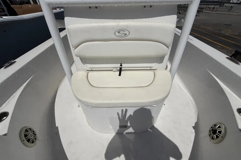 Slide: The Image of 2013 Sportsman Masters 227 Bay Boat interior with white seating and shadow reflection. - 12