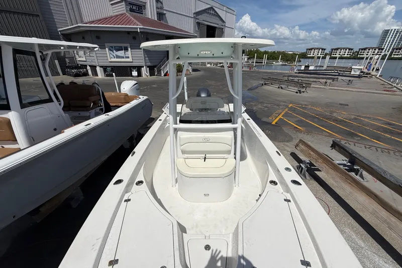 Slide: The Image of 2013 Sportsman Masters 227 Bay Boat docked at marina, clear sky background. - 8