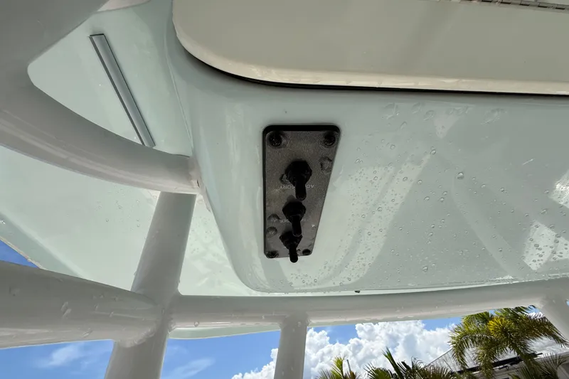 Slide: The Image of 2013 Sportsman Masters 227 Bay Boat T-top with control panel, under clear sky. - 20