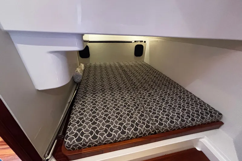 Slide: The Image of 2015 Pursuit SC 365i Sport Coupe cabin with patterned mattress and cozy interior. - 17