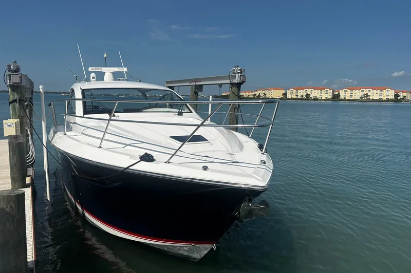 Slide: The Image of 2015 Pursuit SC 365i Sport Coupe docked by waterfront buildings. - 3