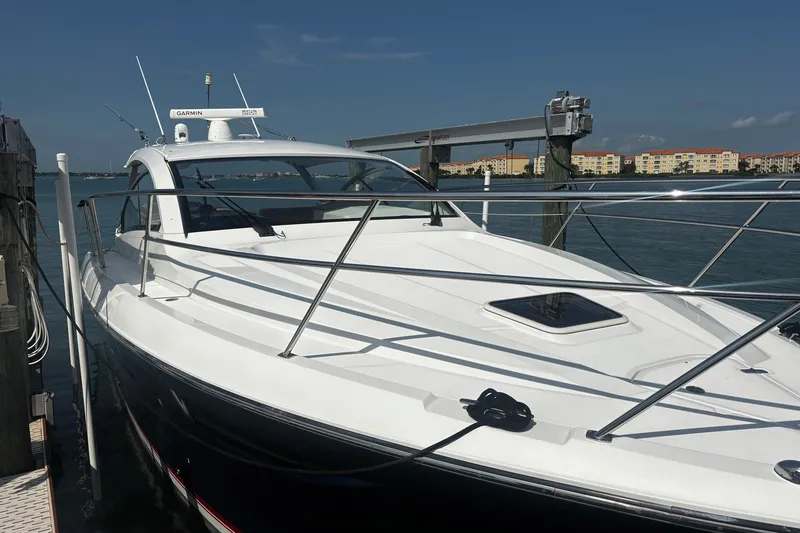Slide: The Image of 2015 Pursuit SC 365i Sport Coupe docked at marina under clear blue sky. - 6