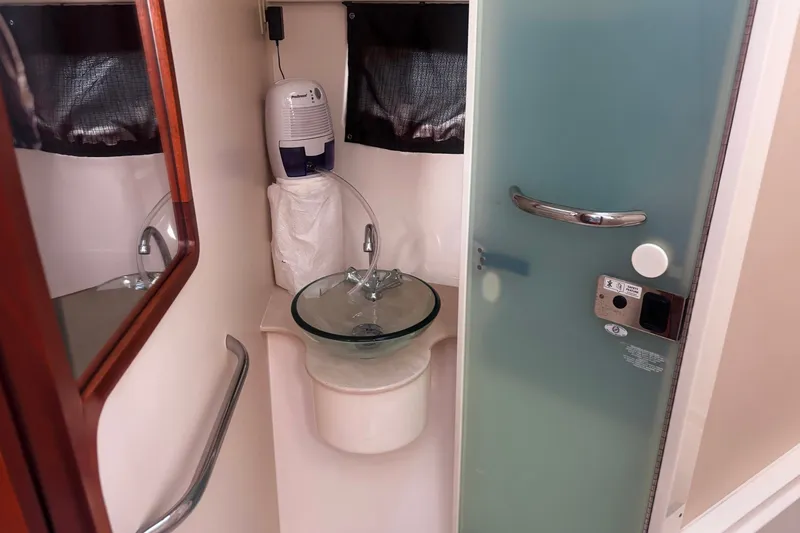 Slide: The Image of Compact bathroom in 2015 Pursuit SC 365i Sport Coupe with glass sink and frosted door. - 13