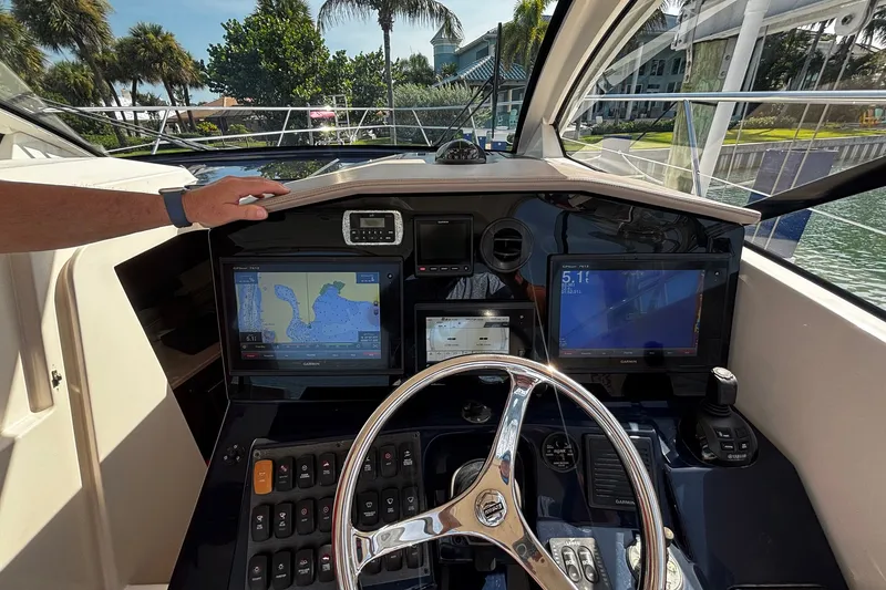 Slide: The Image of Helm of 2015 Pursuit SC 365i Sport Coupe with navigation screens and controls. - 21