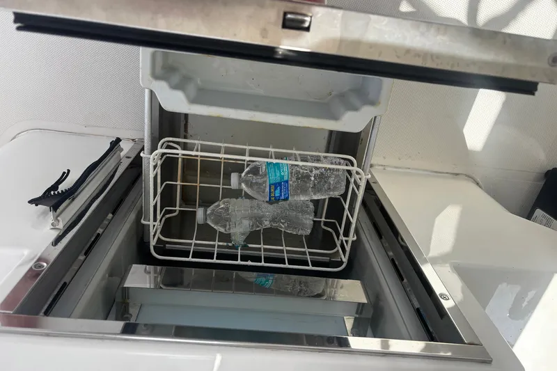 Slide: The Image of Open cooler with ice and water bottles on a 2015 Pursuit SC 365i Sport Coupe. - 26