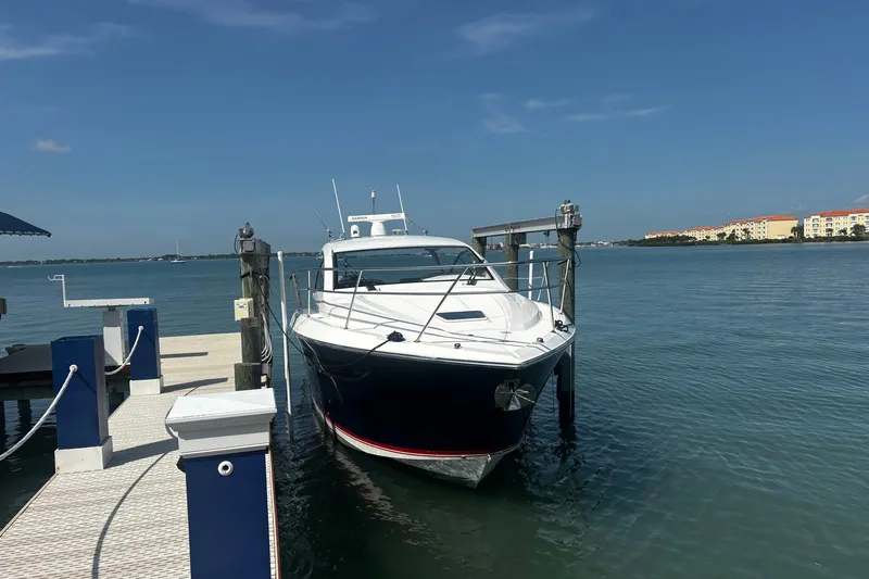 Slide: The Image of 2015 Pursuit SC 365i Sport Coupe docked by the waterfront on a sunny day. - 4