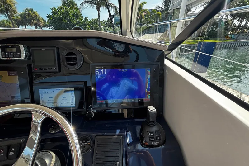 Slide: The Image of Dashboard of a 2015 Pursuit SC 365i Sport Coupe with navigation screens and controls. - 22
