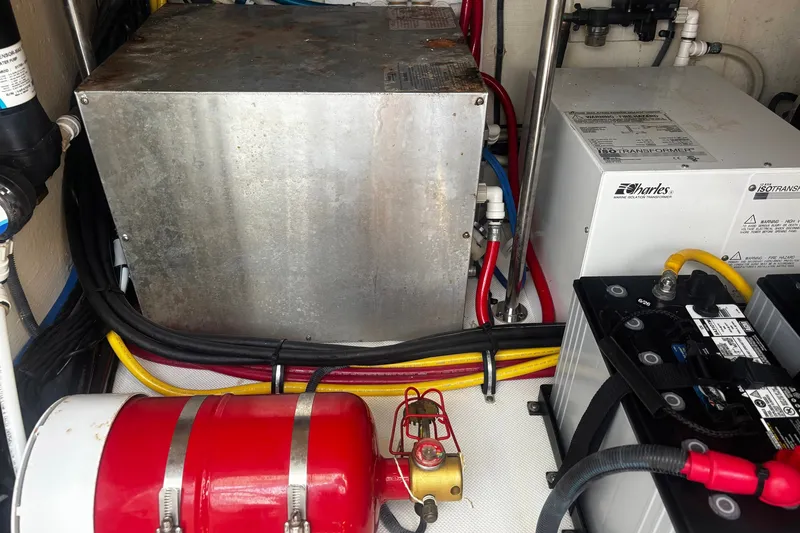 Slide: The Image of Engine compartment of a 2015 Pursuit SC 365i Sport Coupe with electrical components and fire extinguisher. - 27