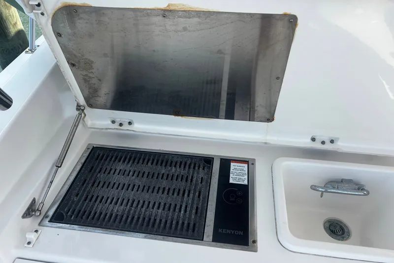 Slide: The Image of Outdoor grill and sink on 2015 Pursuit SC 365i Sport Coupe boat. - 25