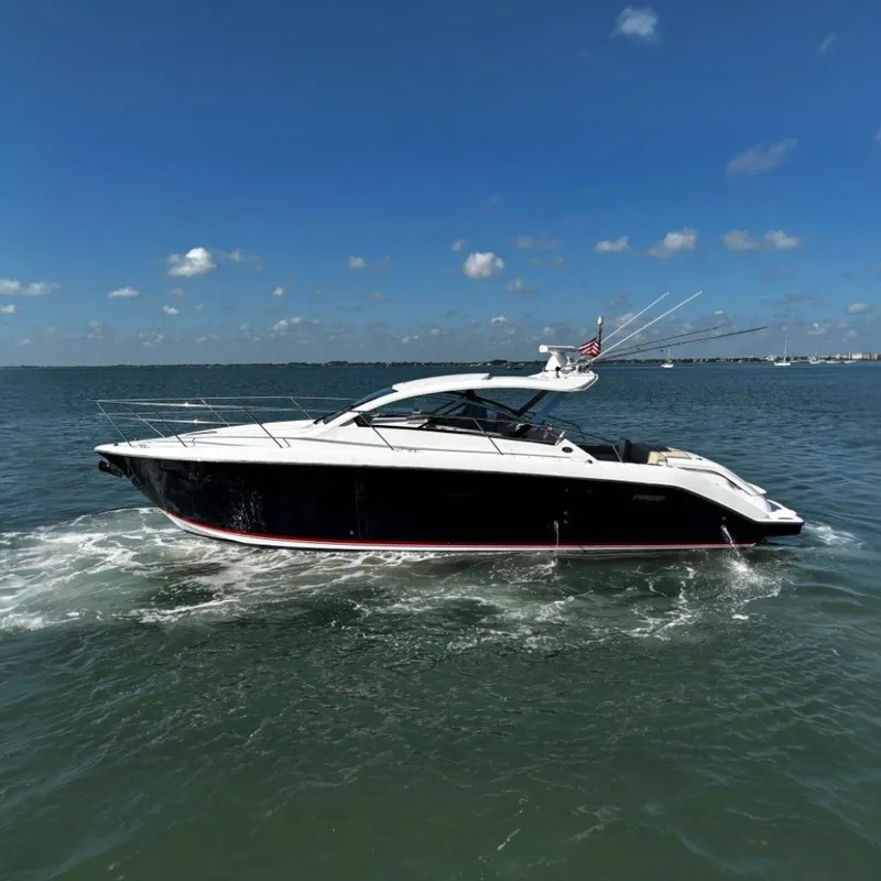Slide: The Image of 2015 Pursuit SC 365i Sport Coupe on the water with clear skies. - 0