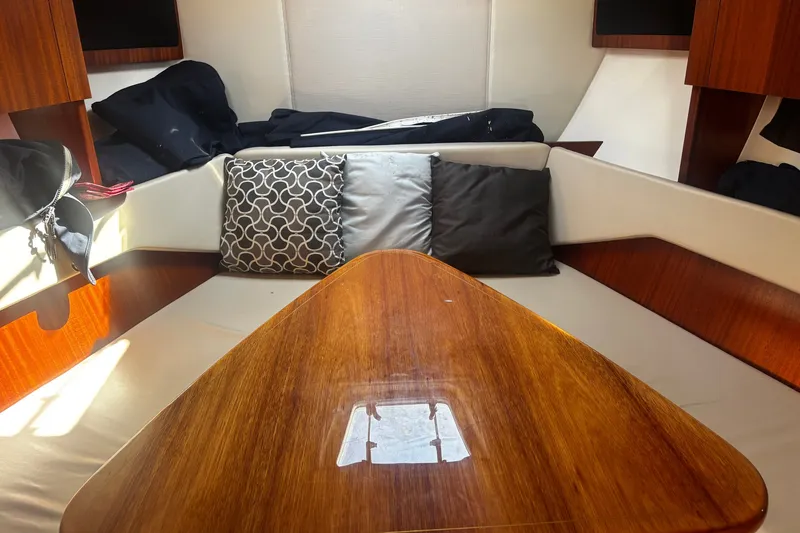 Slide: The Image of Interior of 2015 Pursuit SC 365i Sport Coupe with cushions and wooden table. - 10