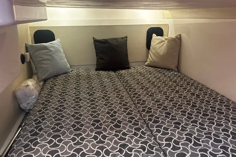 Slide: The Image of Interior cabin of 2015 Pursuit SC 365i Sport Coupe with patterned bedding and pillows. - 16