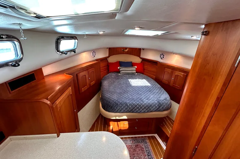 Slide: The Image of Luxurious cabin interior of 2007 Legacy 32 yacht with cozy bed and wooden furnishings. - 19