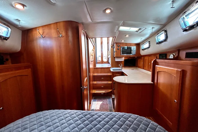 Slide: The Image of Luxurious 2007 Legacy 32 yacht interior with wood cabinetry and modern amenities. - 21