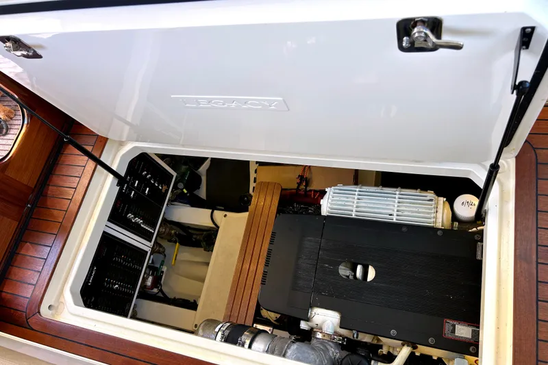 Slide: The Image of Engine compartment of a 2007 Legacy 32 boat, showcasing mechanical components and systems. - 26