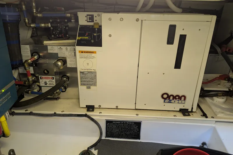 Slide: The Image of Engine room of a 2007 Legacy 32 with Onan generator and various mechanical components. - 28