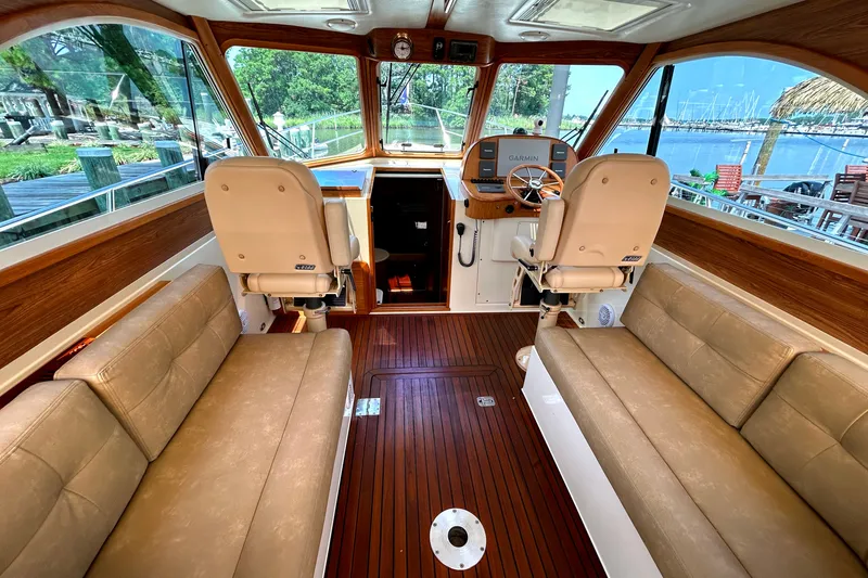 Slide: The Image of Interior of 2007 Legacy 32 boat with leather seating and wooden flooring. - 15