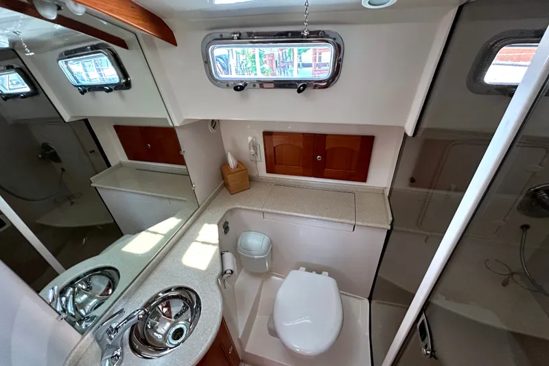 Slide: The Image of Luxurious 2007 Legacy 32 yacht bathroom with modern fixtures and ample natural light. - 23