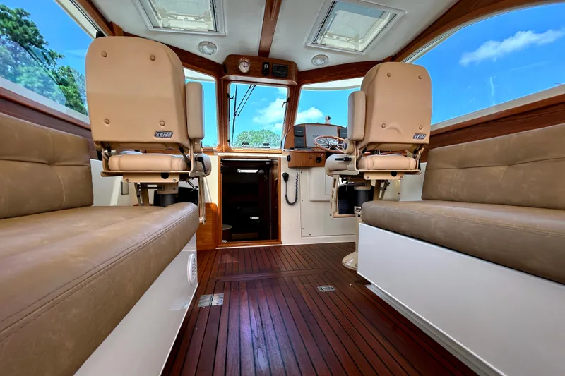 Slide: The Image of Interior of 2007 Legacy 32 boat with leather seats and wooden flooring. - 16