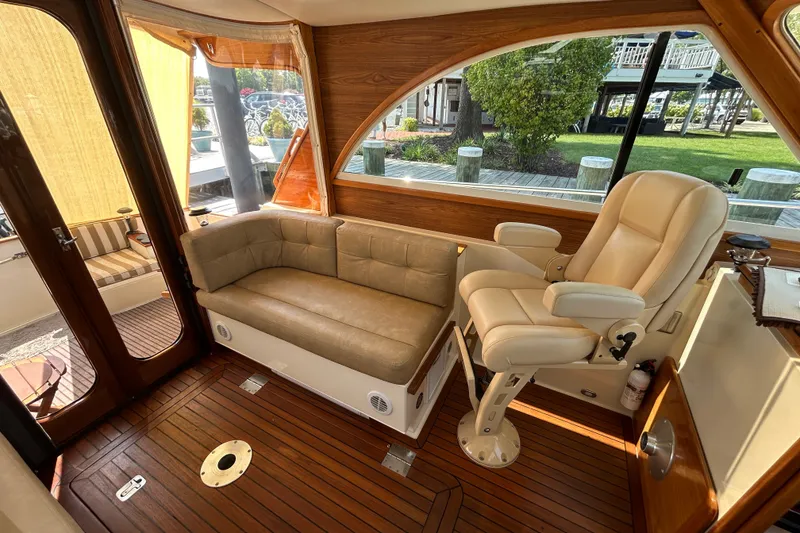 Slide: The Image of Luxurious 2007 Legacy 32 yacht interior with leather seating and wooden flooring. - 14
