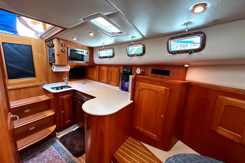Slide: The Image of Luxurious 2007 Legacy 32 yacht interior with wood cabinetry and modern amenities. - 17