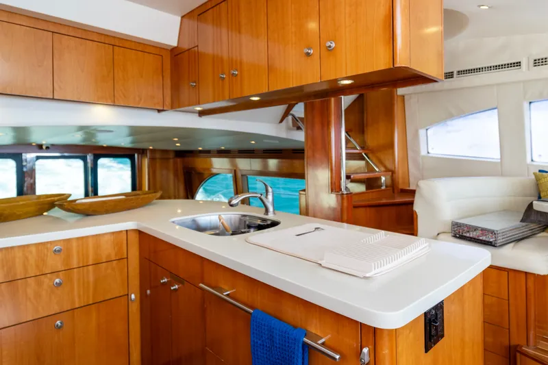 Slide: The Image of Luxurious kitchen interior of 2008 Hatteras 64 Motor Yacht with wooden cabinetry and modern amenities. - 10